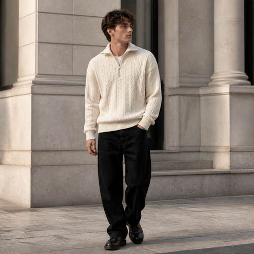 Off white cable knit half zip sweater worn outdoors in a walking lifestyle pose.