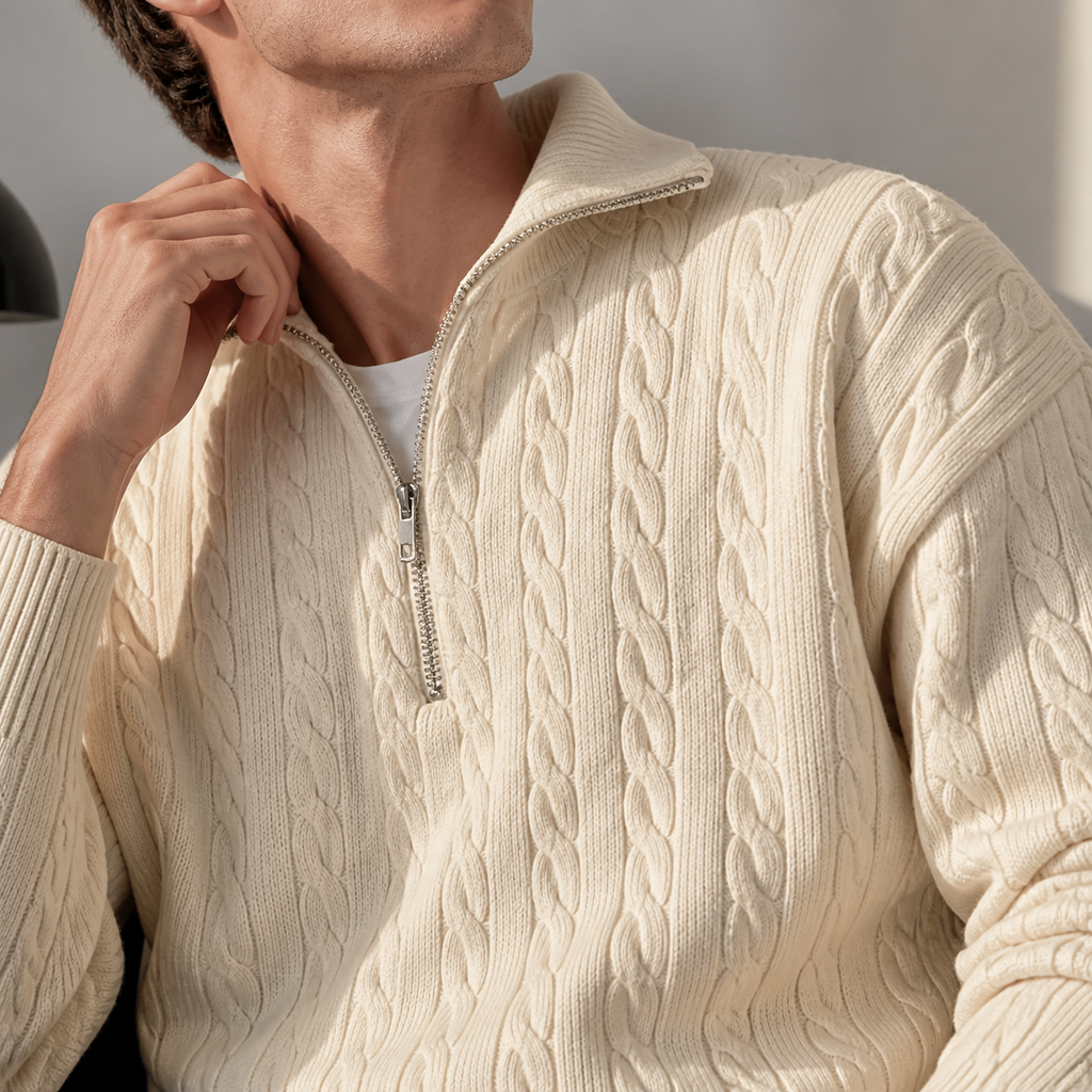 Close-up of the off white cable knit half zip sweater collar, zipper and cable texture.