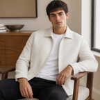 Beige textured weave lapel jacket worn seated indoors in a relaxed lifestyle pose.