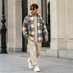 Mixed color plaid overshirt jacket worn outdoors in a walking lifestyle pose.