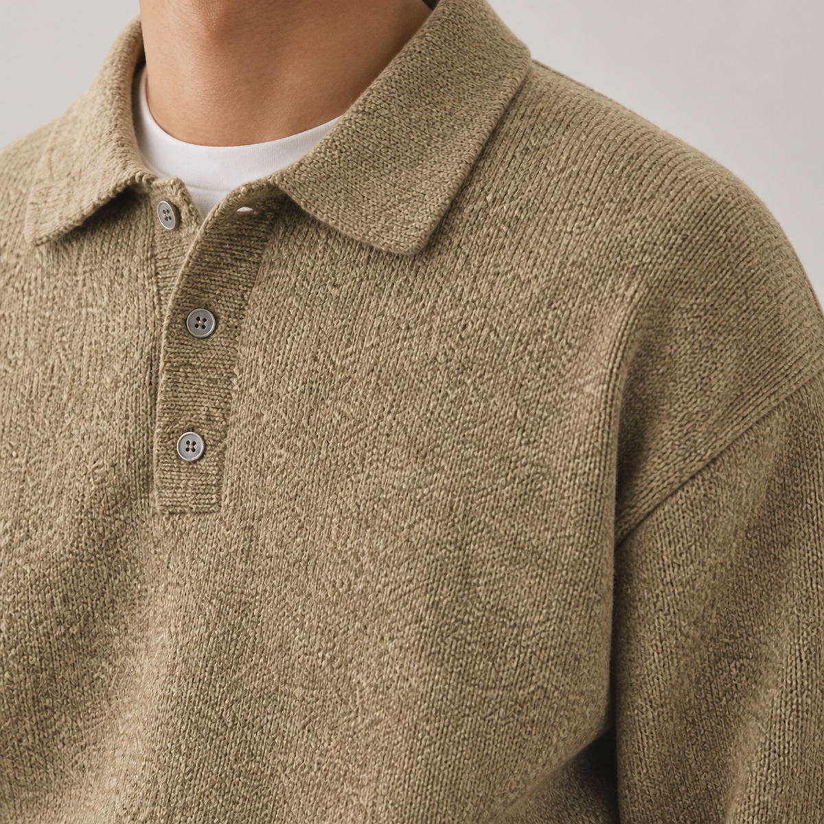 Close-up of the yellow brown polo collar sweater buttons, collar and knit texture.