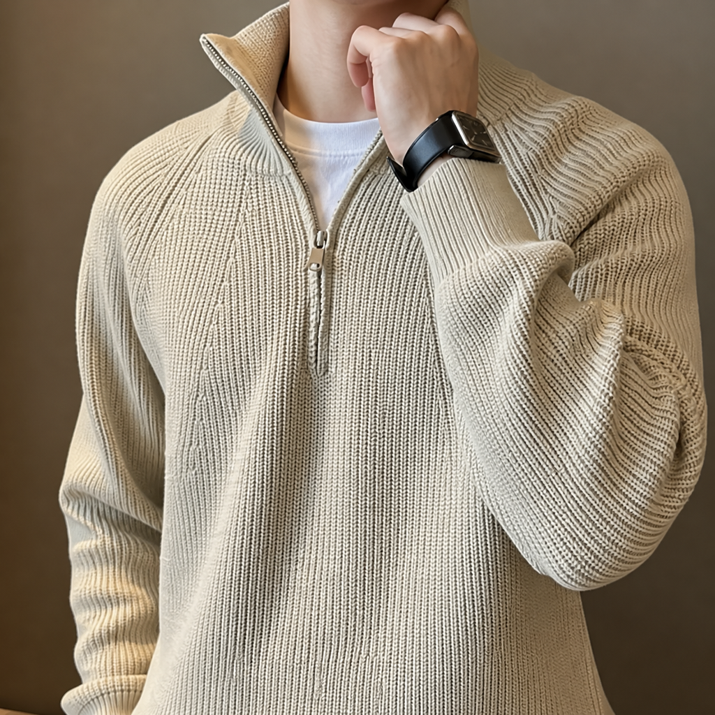 Close-up of the beige quarter zip sweater stand collar, zipper and ribbed knit texture.