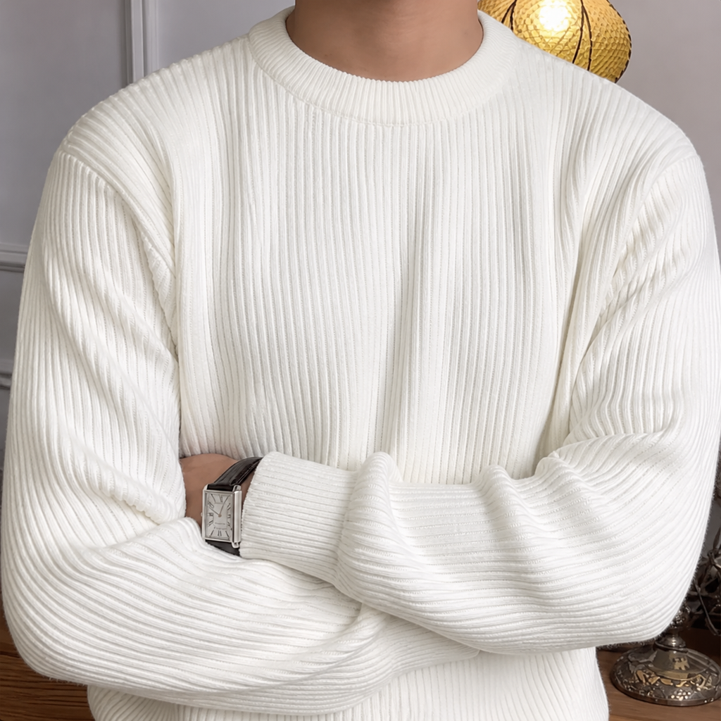 Close-up of the ivory white ribbed crew neck sweater neckline and vertical knit texture.