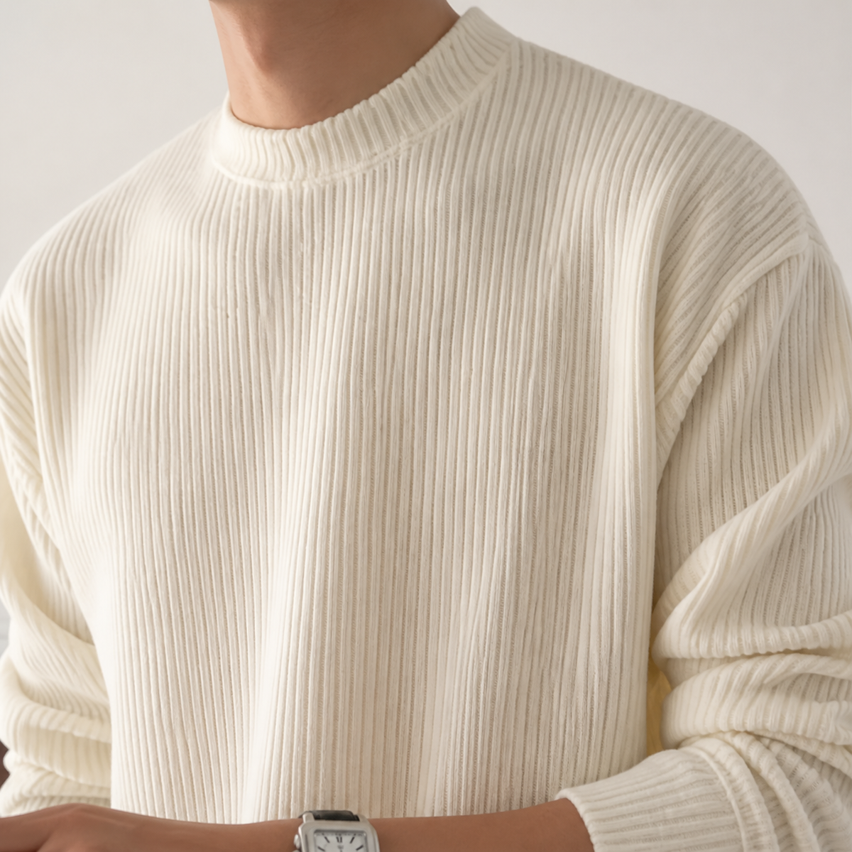 Close-up of the ivory white structured ribbed sweater neckline and vertical knit texture.