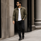 Military green suede look workwear jacket worn outdoors in a walking lifestyle pose.