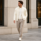 White ribbed zip up knit cardigan worn outdoors in a walking lifestyle pose.