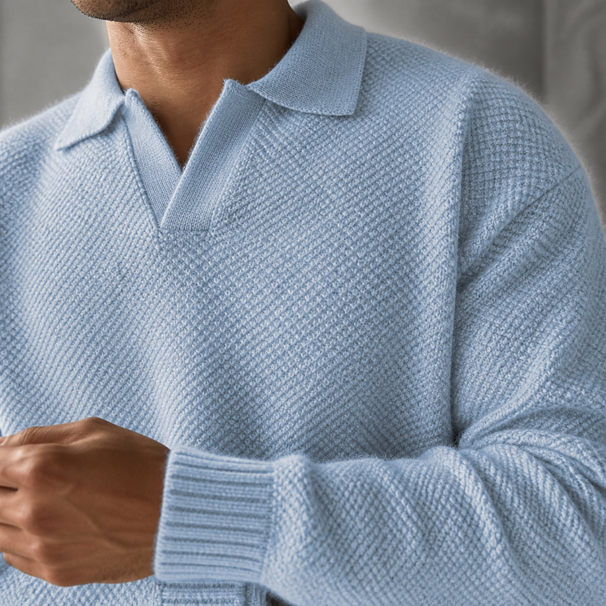 Close-up of the light blue polo collar sweater neckline and textured knit.