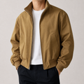 Khaki stand collar bomber jacket on a male model in a clean studio.