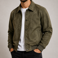 Military green oversized workwear jacket on a male model in a clean studio.