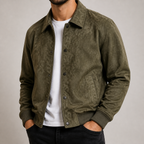 Military green oversized workwear jacket on a male model in a clean studio.